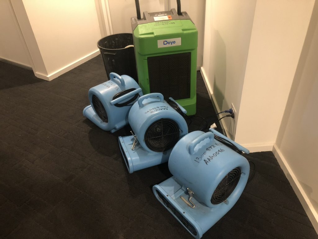 Air movers and a dehumidifier running after a water damage job