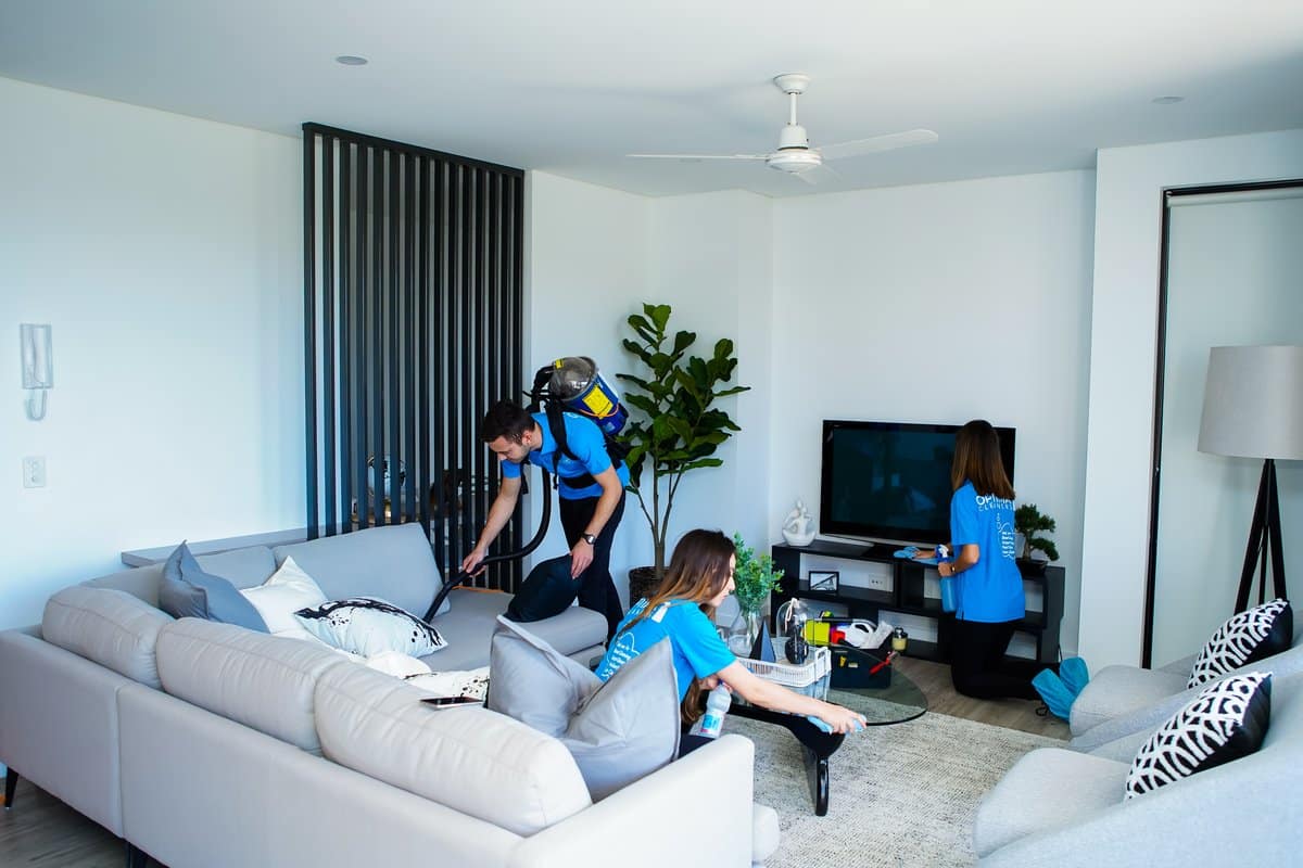 How to clean house fast: Optima Cleaners team working through a living room