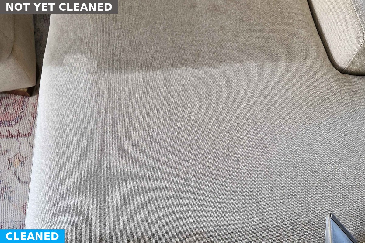 Half cleaned chaise showing the difference a steam clean makes to fabric upholstery
